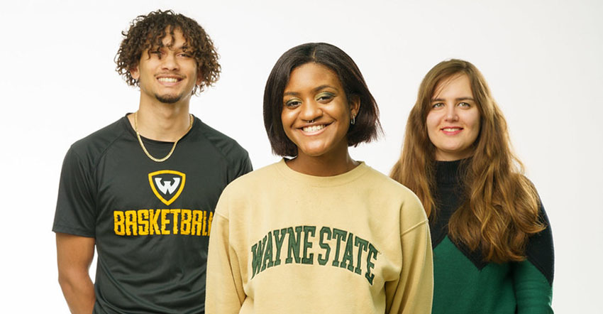 Three students wearing WSU shirts smiling