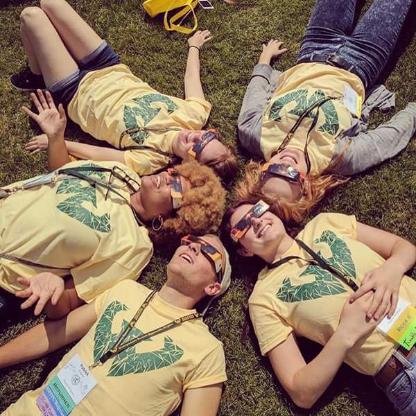 Peer mentors lying on the ground in a circle