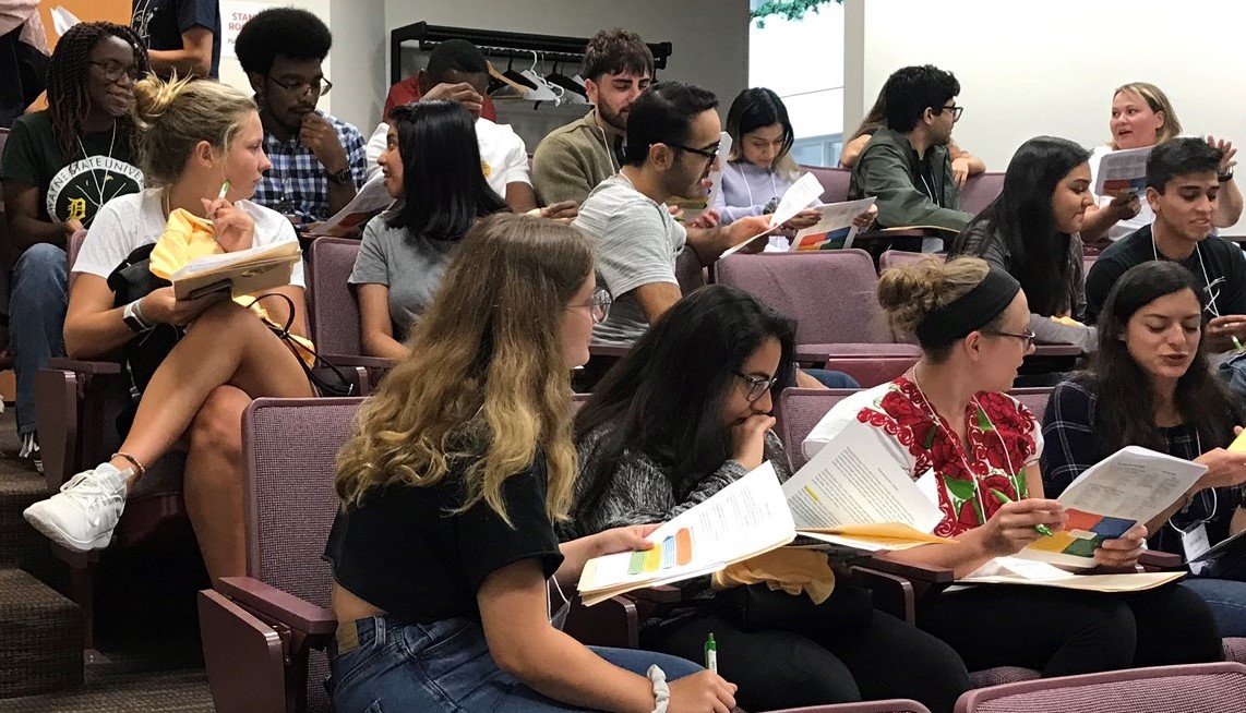 Groups of students chatting during an activity